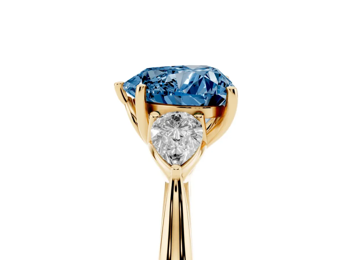 Fancy Blue Heart Cut Diamond Three-Stone Ring with Pear Side Stones and Prong Setting Yellow gold