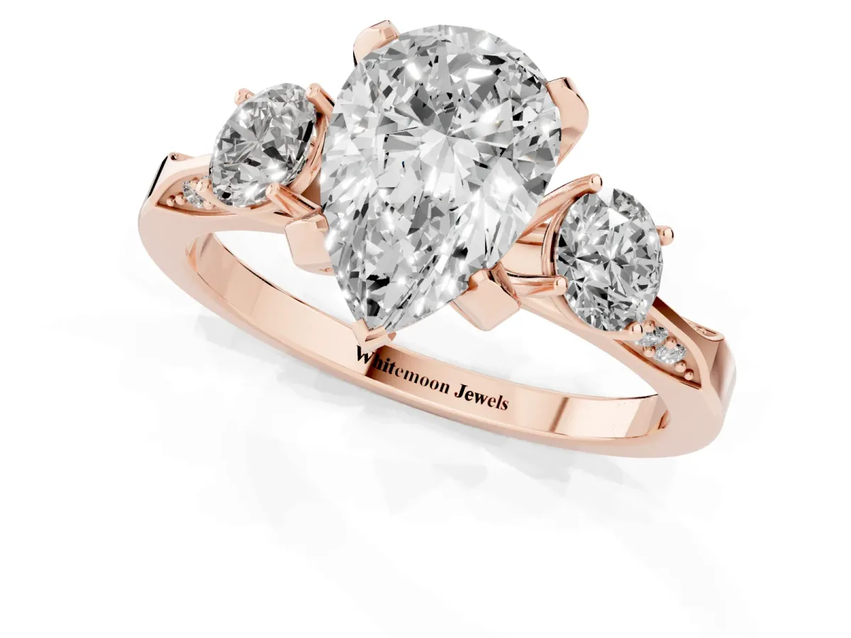Pear Cut Brilliant Three-Stone Diamond Ring with Pavé Band and Four-Prong Setting Rose gold