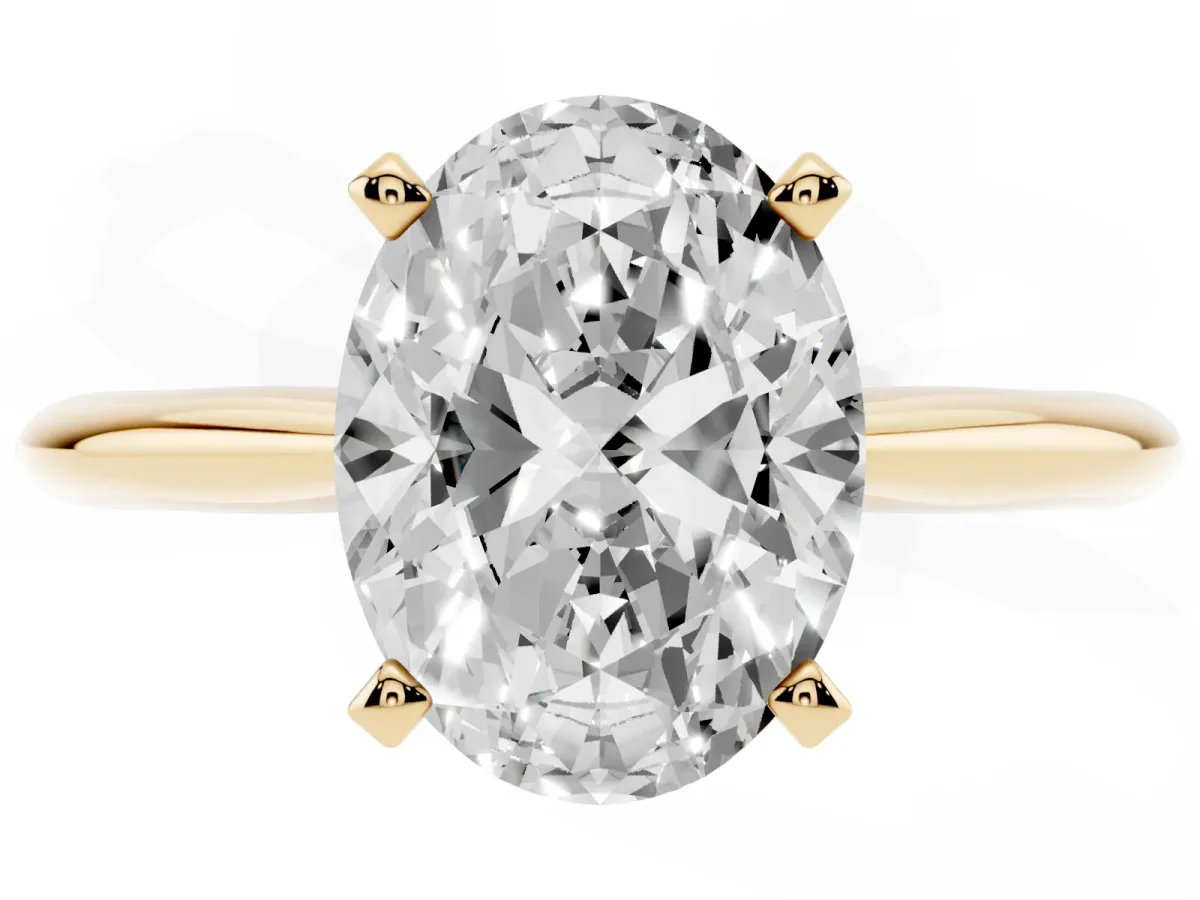Oval Cut Cut Solitaire Ring with Four-Prong Setting on a Classic Band Yellow gold
