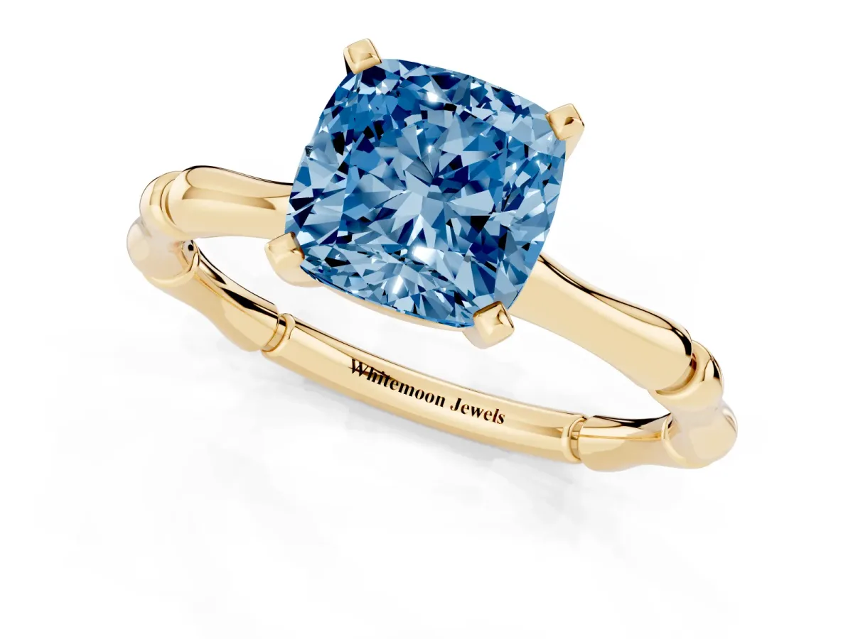 Fancy Blue Cushion Cut Solitaire Diamond Ring with Bamboo Band and Four-Prong Setting Yellow gold