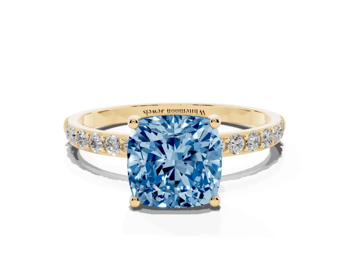Fancy Blue Cushion Cut Diamond Solitaire Ring with Round Pavé Shoulders and Prong Setting Yellow gold