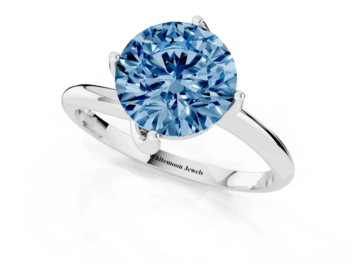 Fancy Blue Round Cut Diamond Solitaire Engagement Ring with Four-Prong Setting and Classic Band Silver