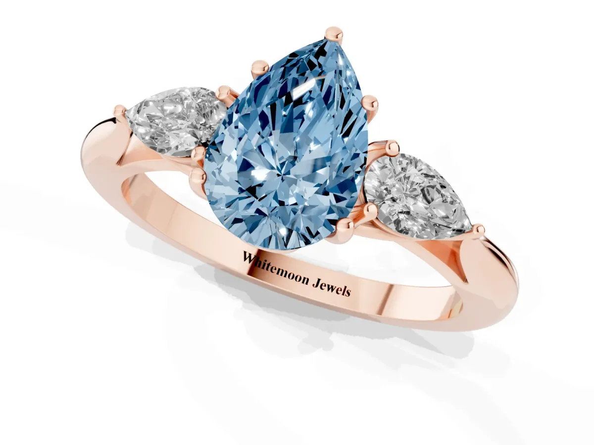 Fancy Blue Pear Cut Diamond Three-Stone Ring with Pear Side Stones and Prong Setting Rose gold