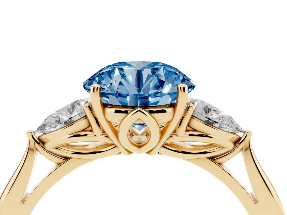 Fancy Blue Three-Stone Round Cut Diamond Ring with Pear Side Stones in Four-Prong Setting Yellow gold