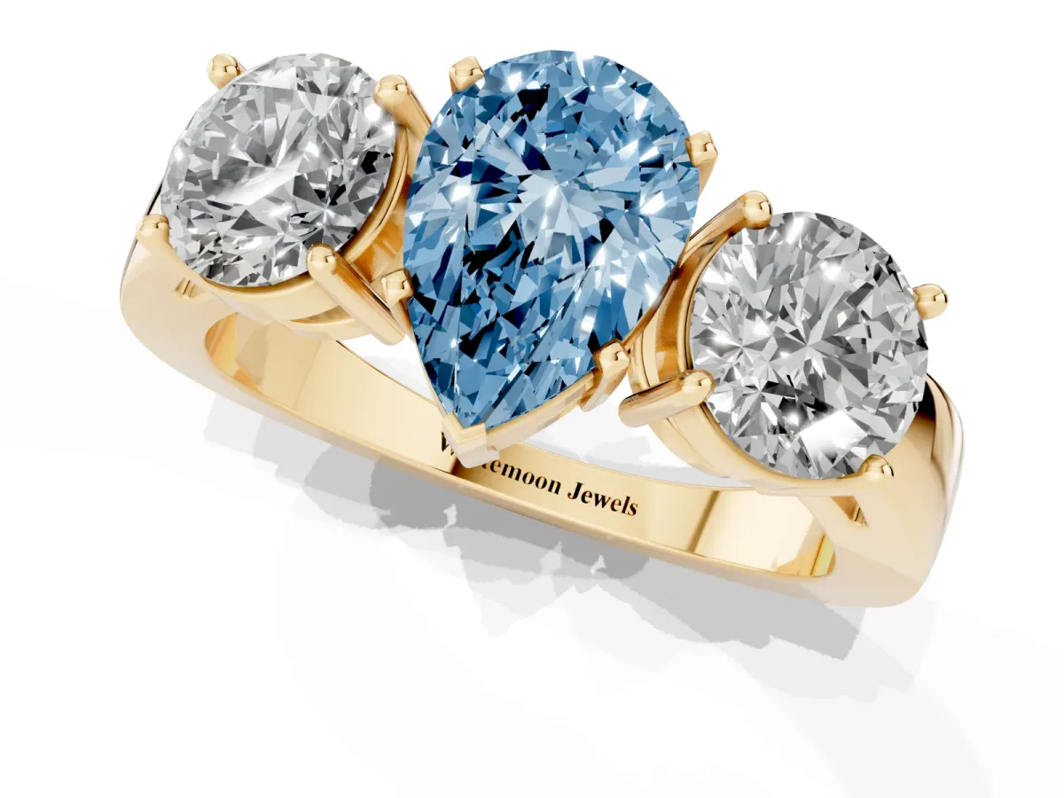 Fancy Blue Three-Stone Pear Cut Diamond Ring with Round Side Stones, Classic Band, and Four-Prong Setting Yellow gold