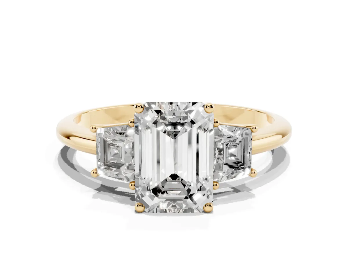 Emerald Cut Diamond Three-Stone Ring with Trapezoid Side Stones and Prong Setting Yellow gold