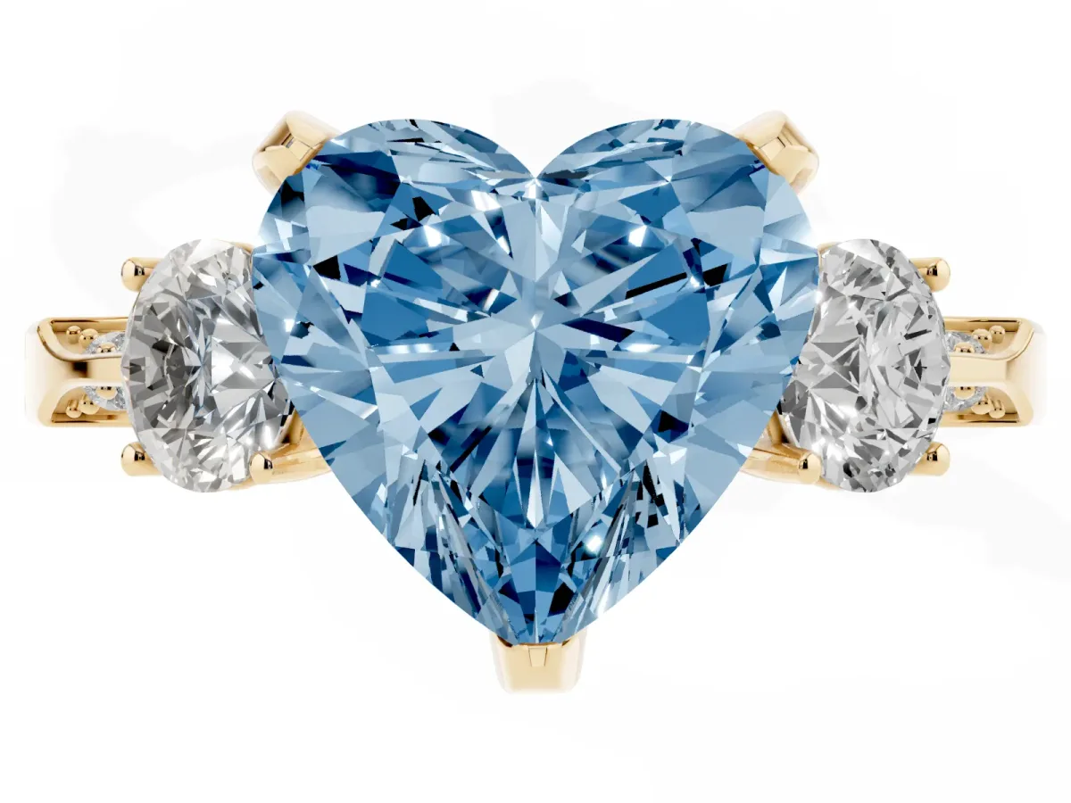 Fancy Blue Heart Cut Brilliant Three-Stone Diamond Ring with Pavé Band and Four-Prong Setting Yellow gold