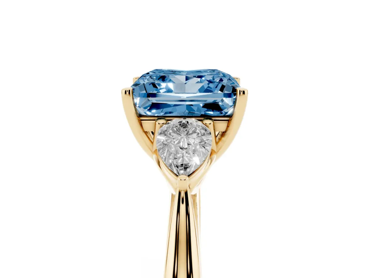 Fancy Blue Princess Cut Diamond Three-Stone Ring with Pear Side Stones and Prong Setting Yellow gold