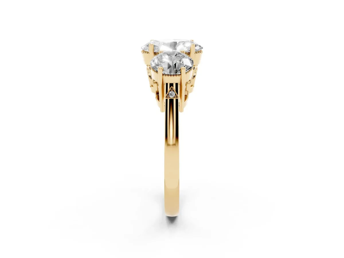 Three-Stone Oval Cut Diamond Engagement Ring with Prong Setting on a Classic Band Yellow gold