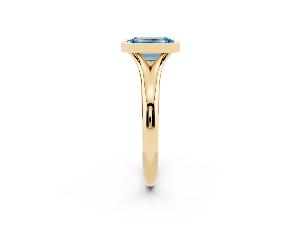 Fancy Blue Bezel Set Emerald Cut Solitaire Diamond Ring with Smooth Band Yellow gold