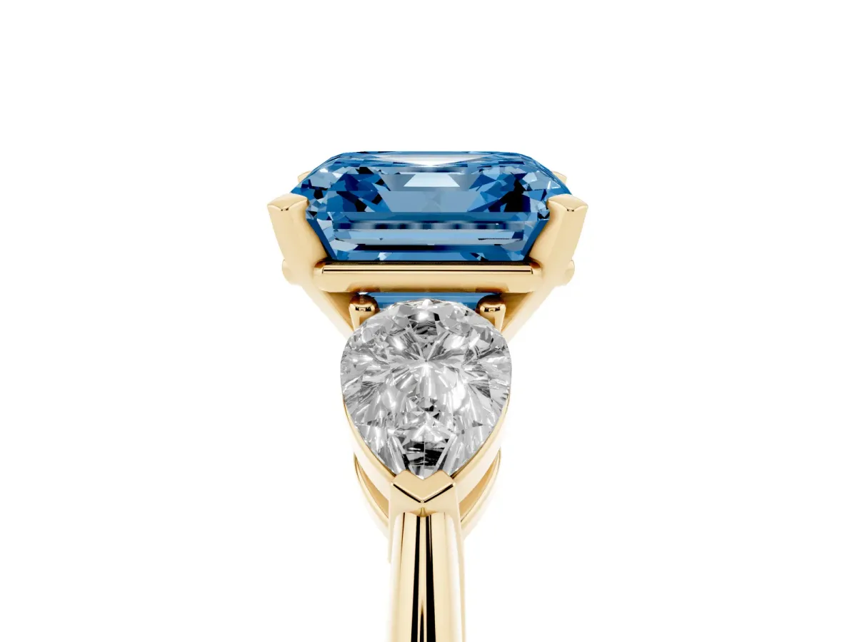 Fancy Blue Three-Stone Asscher Cut Diamond Ring with Pear Side Stones and Four-Prong Setting Yellow gold