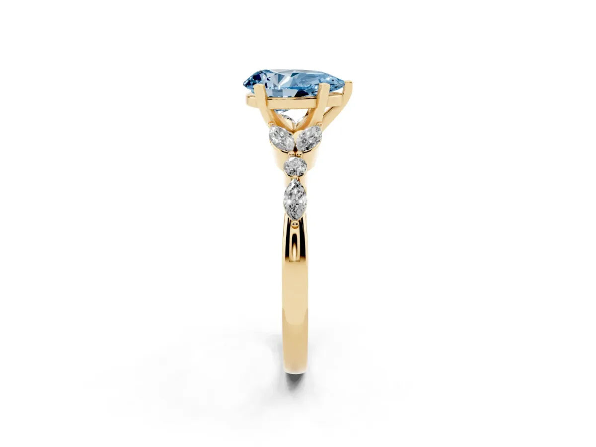 Fancy Blue Pear Cut Diamond Solitaire Ring with Side Stones and Four-Prong Setting Yellow gold
