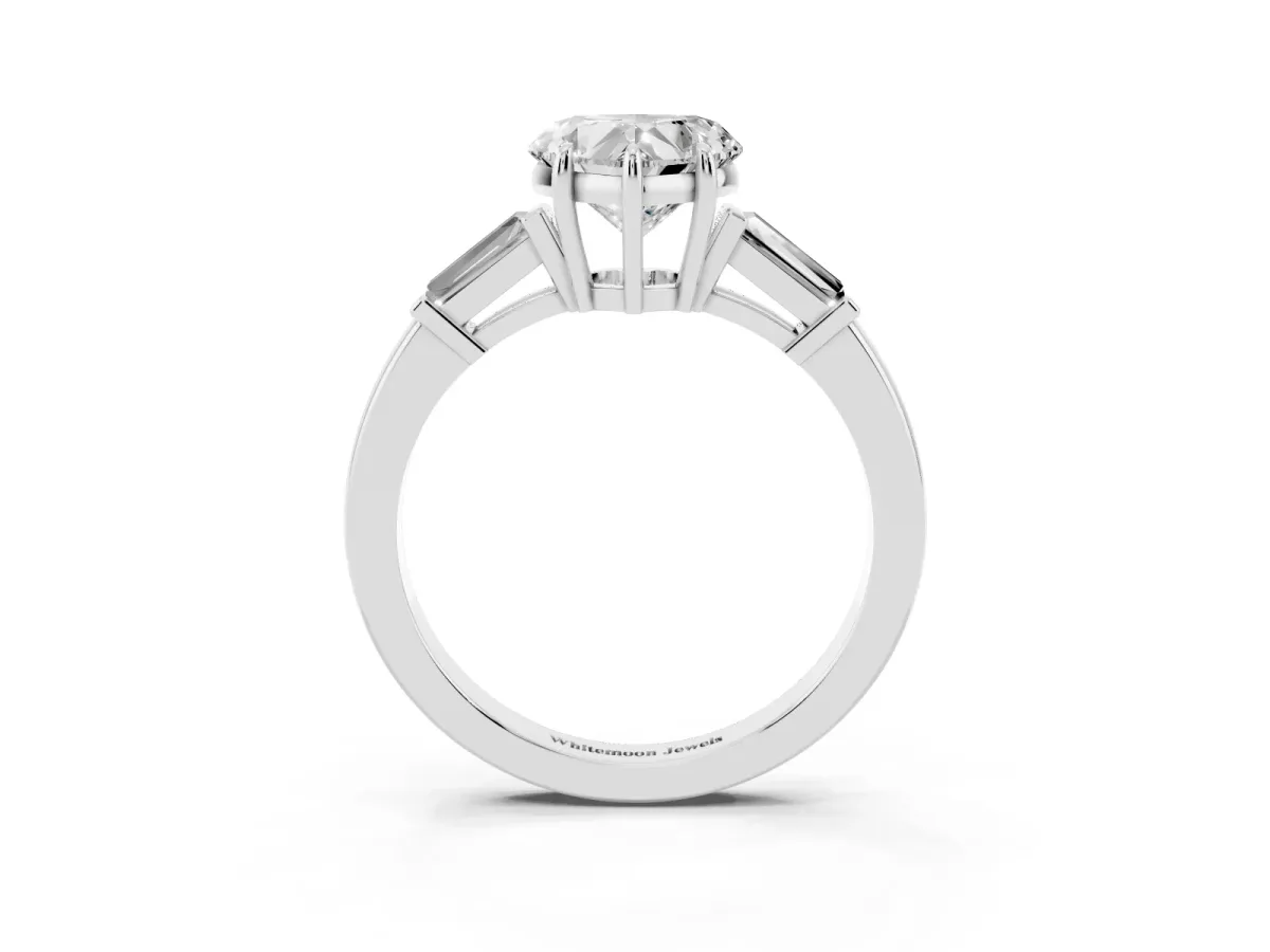 Heart Cut Diamond Three-Stone Ring with Tapered Baguette Side Stones and Prong Setting Platinum