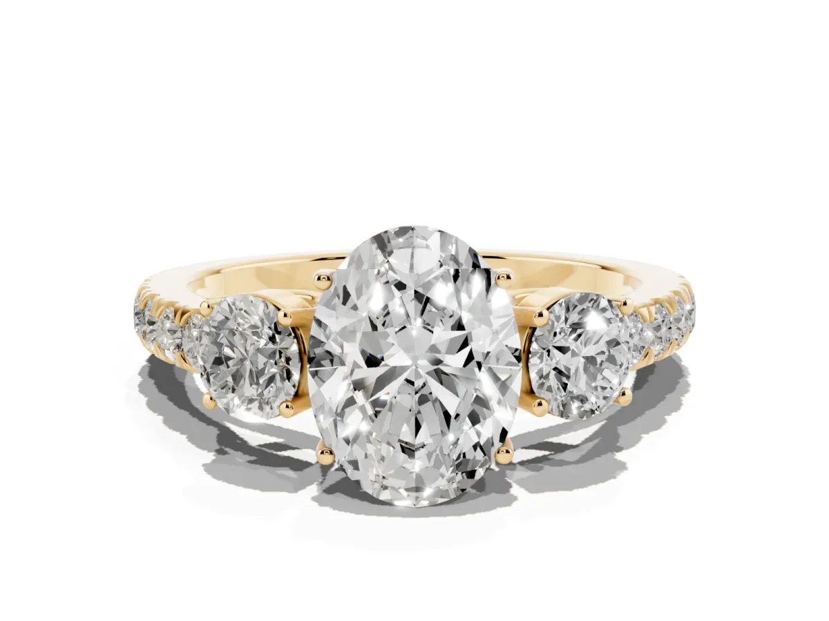 Oval Cut Cut Diamond Three-Stone Ring with Round Side Stones and Pavé Band Yellow gold