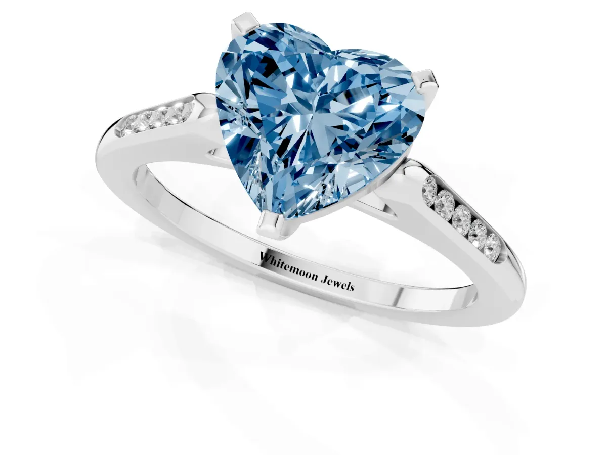 Fancy Blue Heart Cut Diamond Solitaire Ring with Channel Set Round Band and Prong Setting Silver