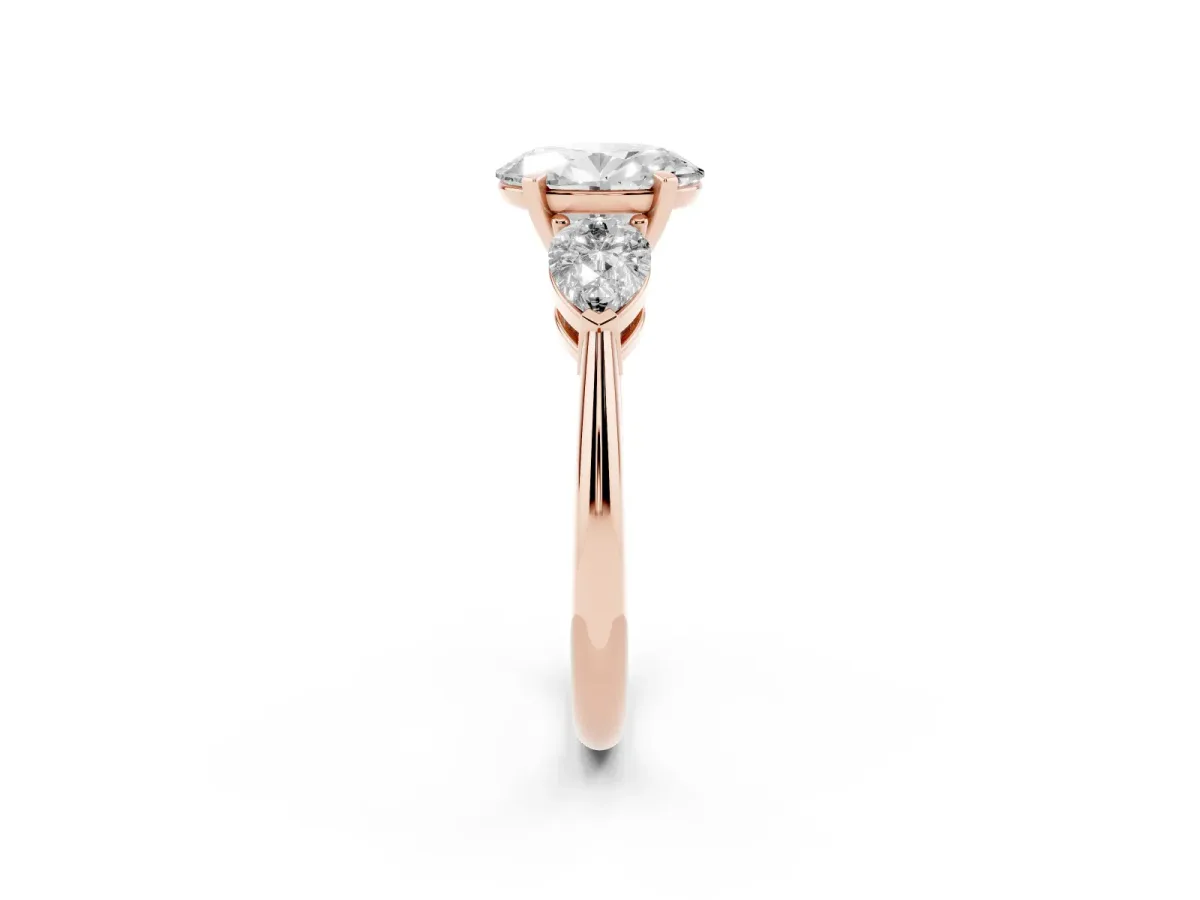 Three-Stone Oval Cut Diamond Ring with Pear Side Stones and Four-Prong Setting Rose gold
