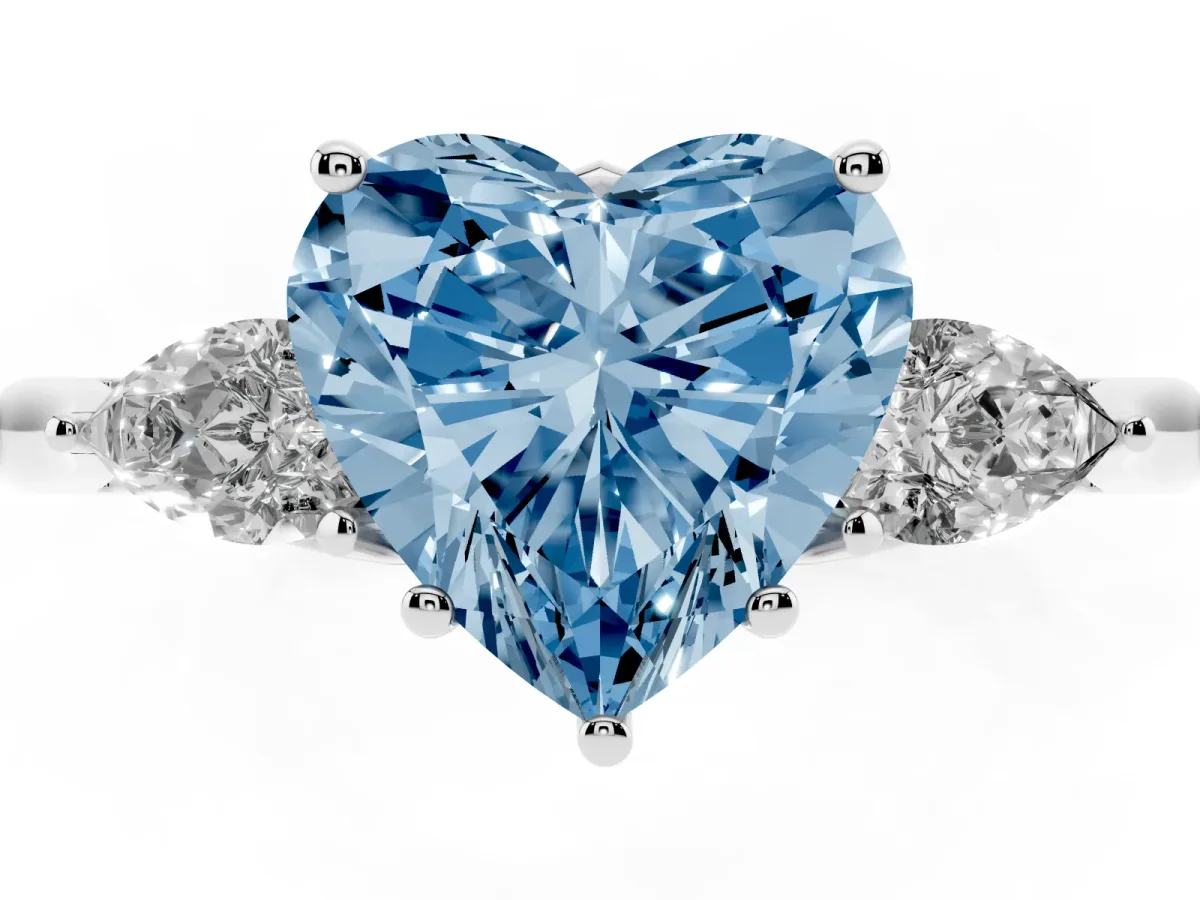 Fancy Blue Three-Stone Heart Cut Brilliant Diamond Solitaire Ring with Tapered Band and Four-Prong Setting White gold