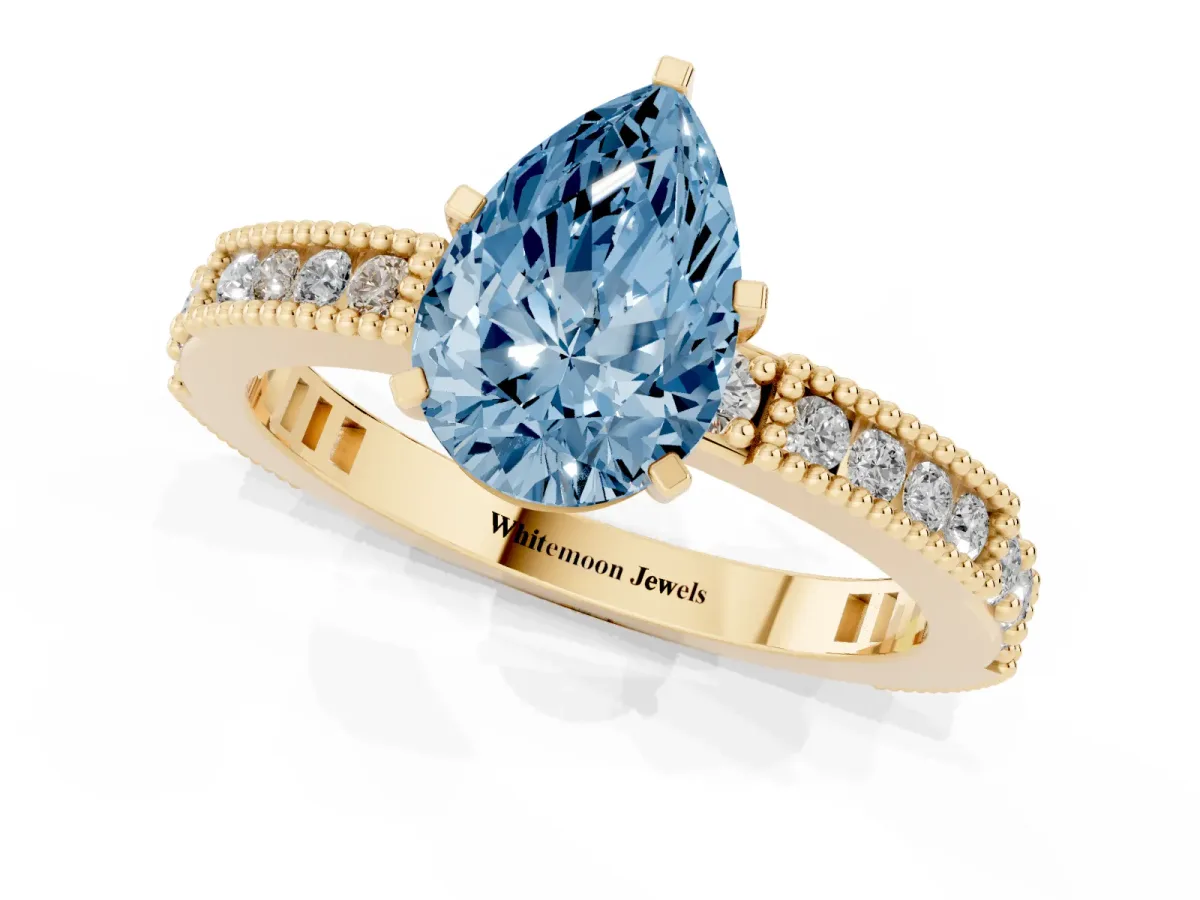 Fancy Blue Pear Cut Solitaire with Pavé Band and Four-Prong Setting Yellow gold