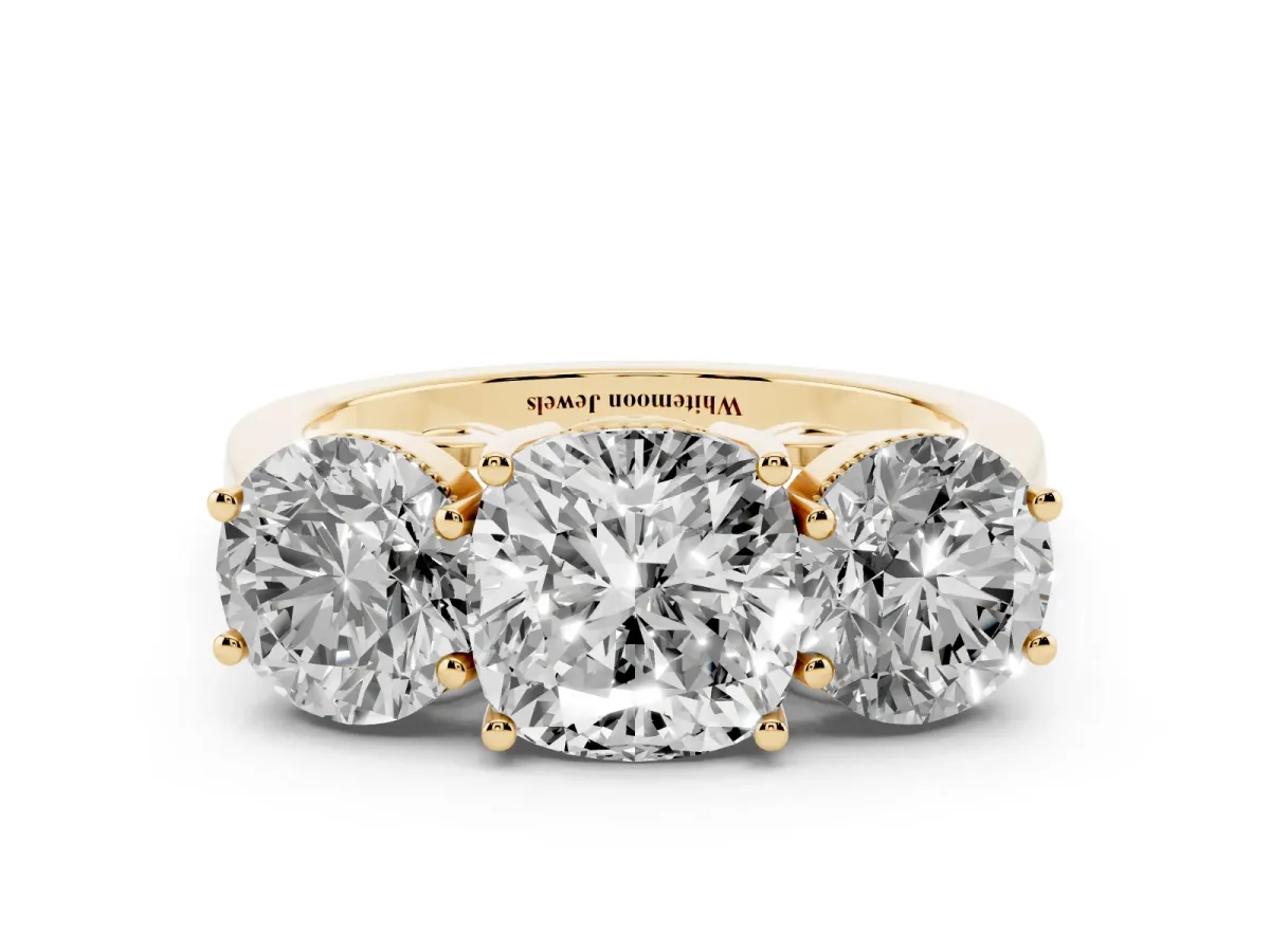 Three-Stone Cushion Cut Diamond Engagement Ring with Prong Setting on a Classic Band Yellow gold