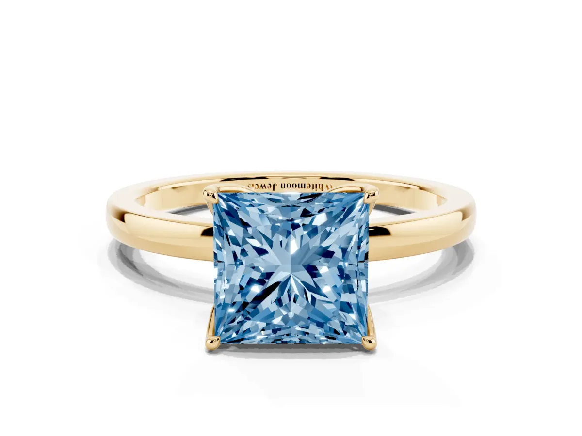 Fancy Blue Princess Cut Diamond Solitaire Ring with Thin Band and Prong Setting Yellow gold