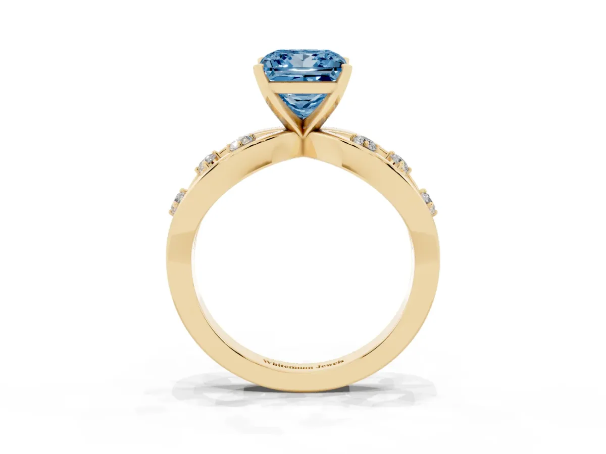Fancy Blue Princess Cut Cut Solitaire Diamond with Side Stones on Criss-Cross Band and Four-Prong Setting Yellow gold