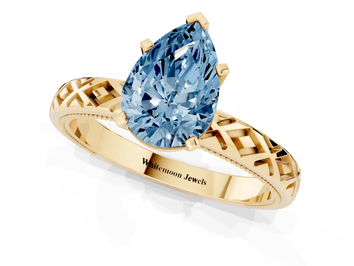 Fancy Blue Pear Cut Solitaire Diamond Ring with Milgrain and Black Enamel X Pattern Band Yellow gold