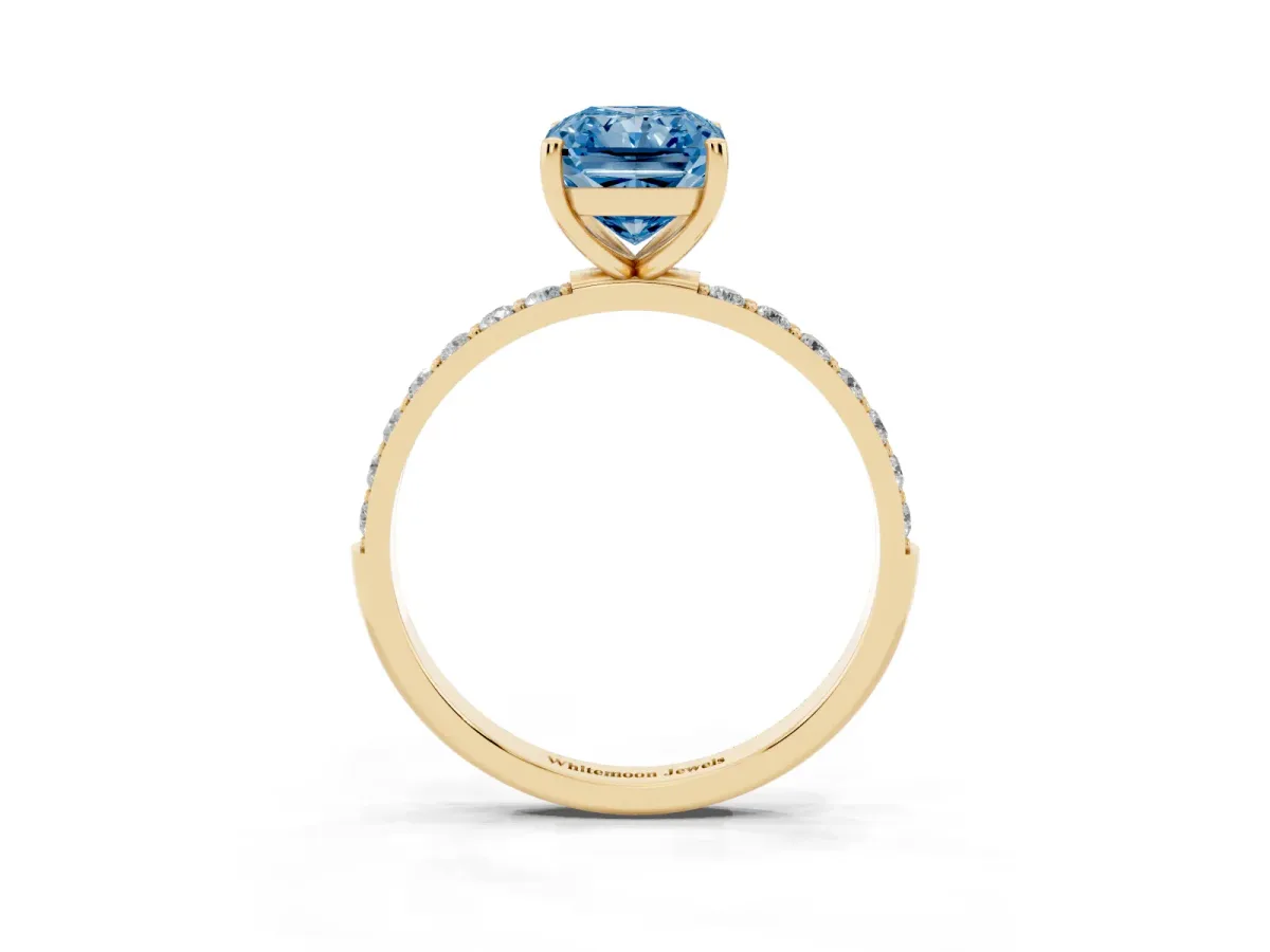 Fancy Blue Radiant Cut Diamond Solitaire Ring with Round Pavé Shoulders and Prong Setting Yellow gold