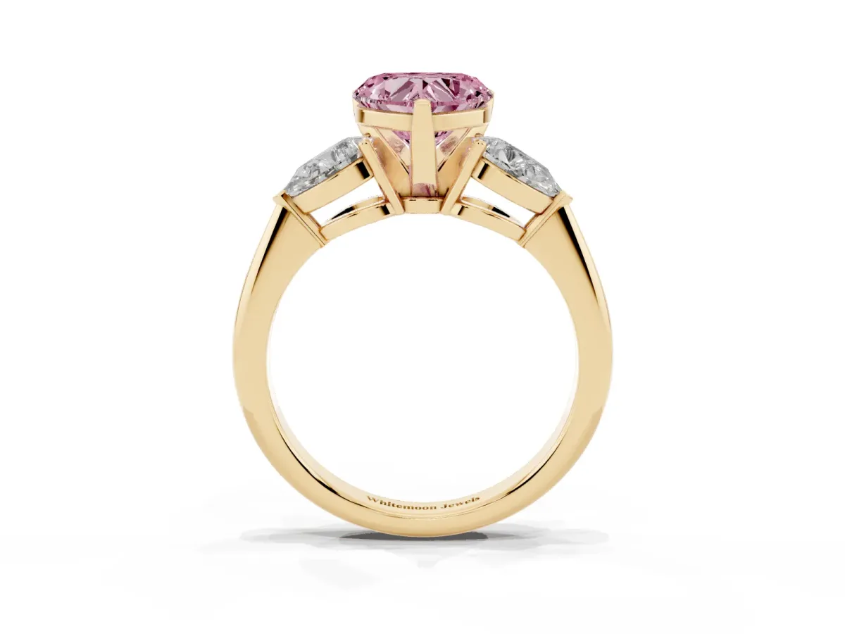 Fancy Pink Three-Stone Heart Cut Diamond Ring with Pear Side Stones and Four-Prong Setting Yellow gold
