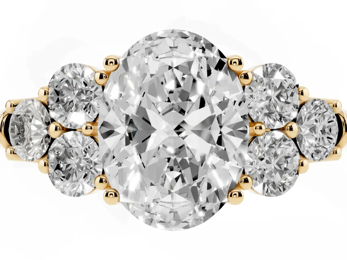 Oval Cut Cut Diamond Cluster Ring with Round Accent Stones and Prong Setting on a Classic Band Yellow gold