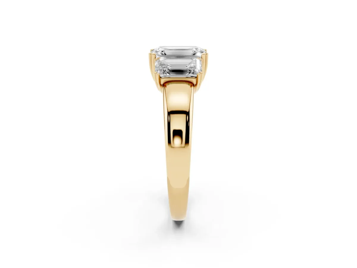 Three-Stone Emerald Cut Cut Diamond Ring with Channel Set Band and Four-Prong Setting Yellow gold