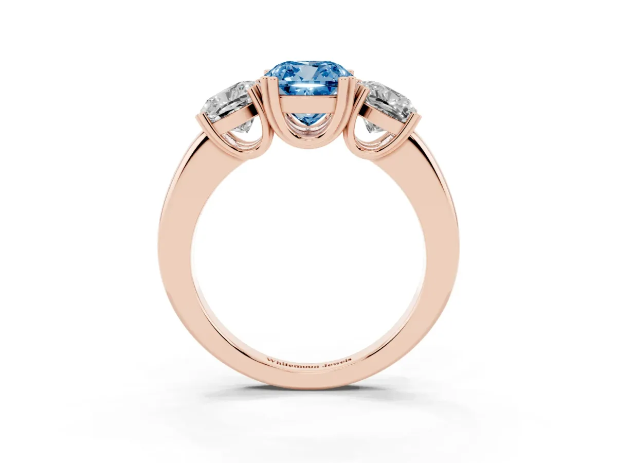 Fancy Blue Three-Stone Cushion Cut Cut Diamond Ring with Channel Set Band and Four-Prong Setting Rose gold