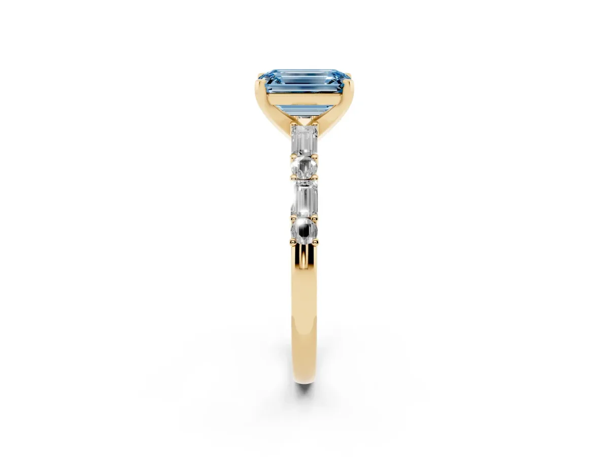 Fancy Blue Emerald Cut Diamond Solitaire with Side Baguettes and Channel Set Band Yellow gold