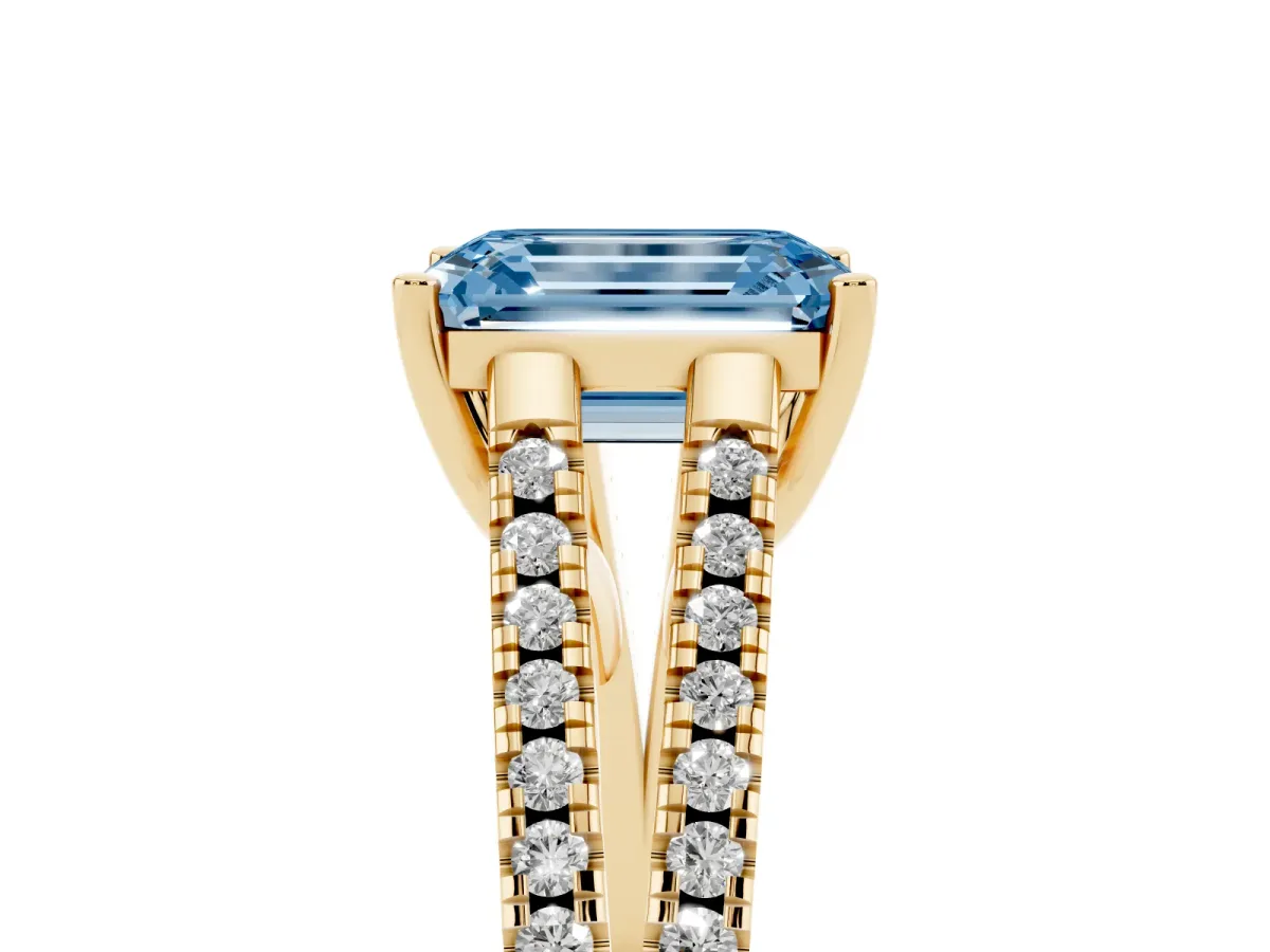 Fancy Blue Emerald Cut Diamond Solitaire Engagement Ring with Split Shank Pavé Band Yellow gold