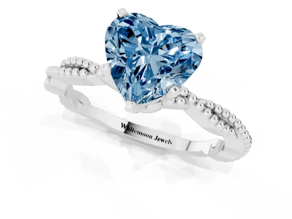 Fancy Blue Heart Cut Solitaire Twisted Band with Bead Prong Setting Platinum