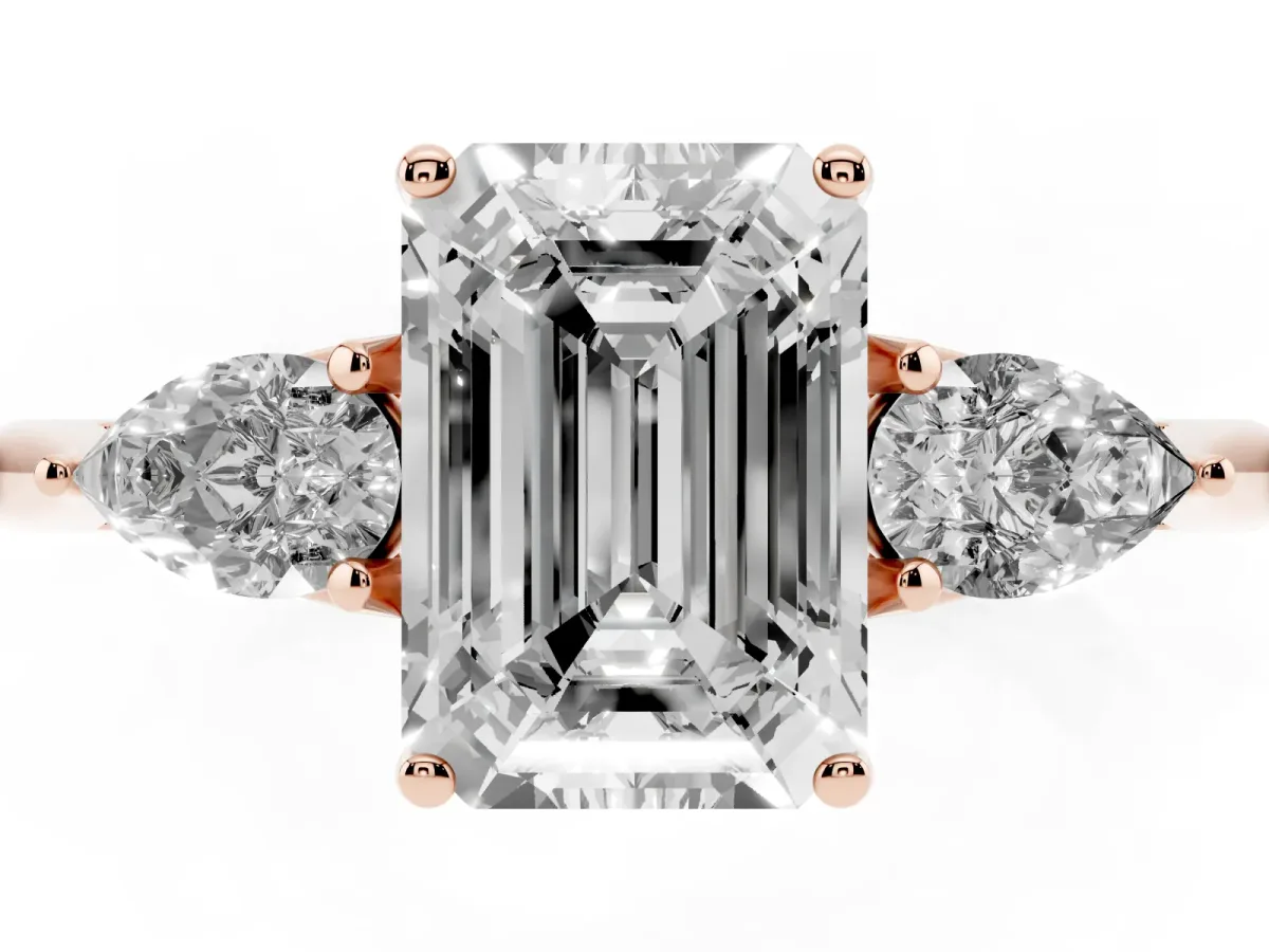 Three-Stone Emerald Cut Diamond Ring with Pear Side Stones in Four-Prong Setting Rose gold
