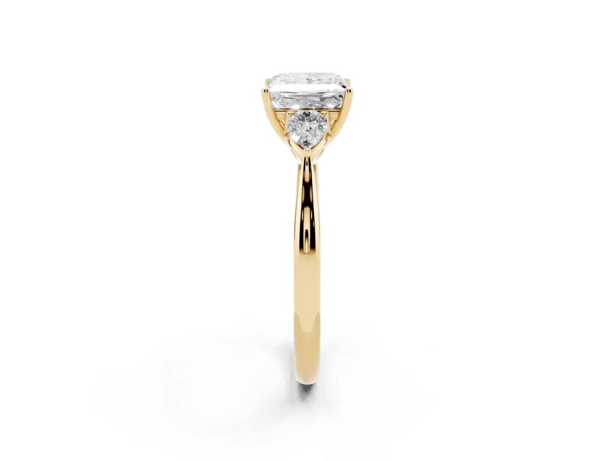 Three-Stone Princess Cut Diamond Ring with Pear Side Stones in Four-Prong Setting Yellow gold
