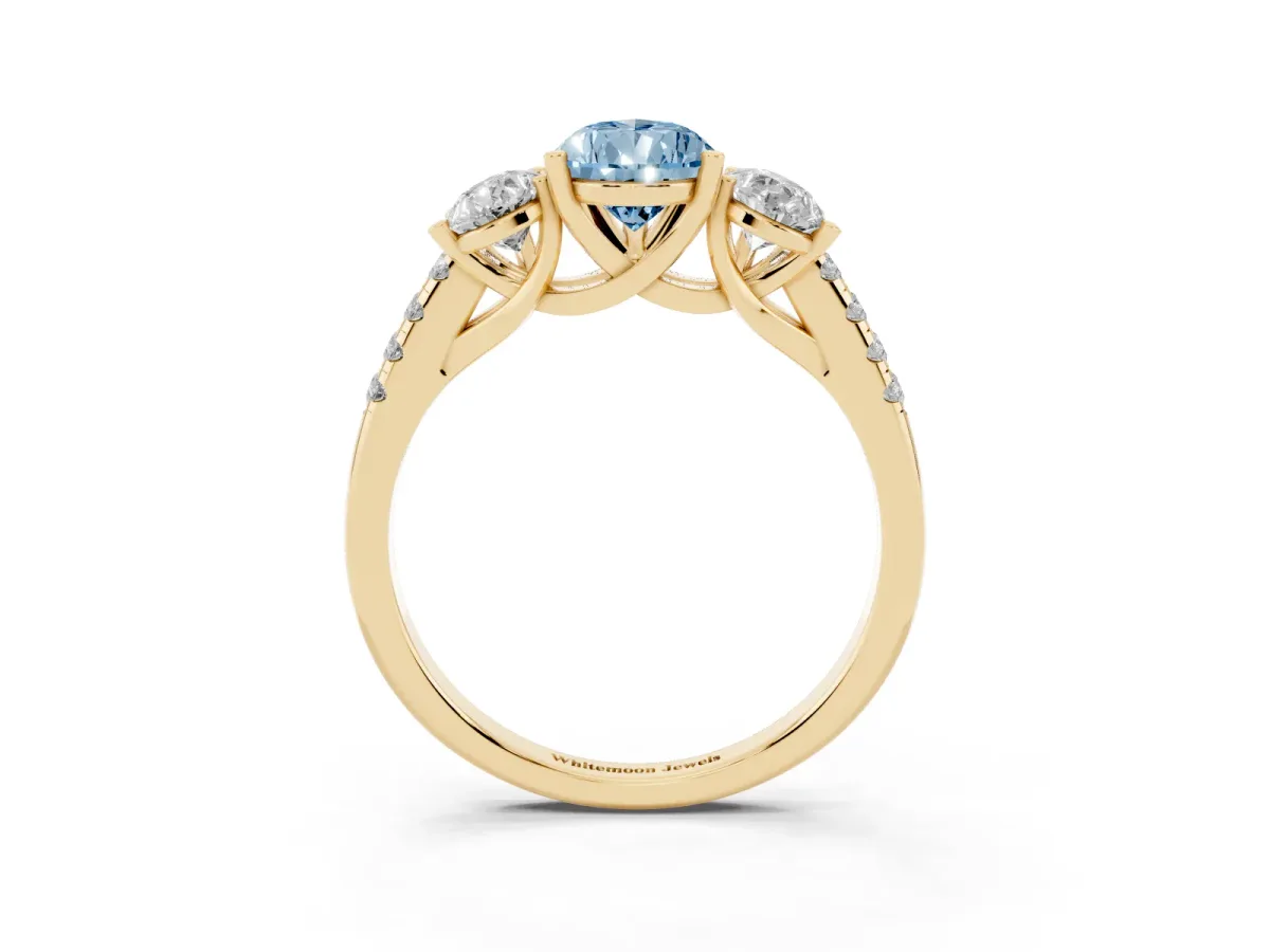 Fancy Blue Three-Stone Pear Cut Diamond Ring with Round Pavé Band and Prong Setting Yellow gold