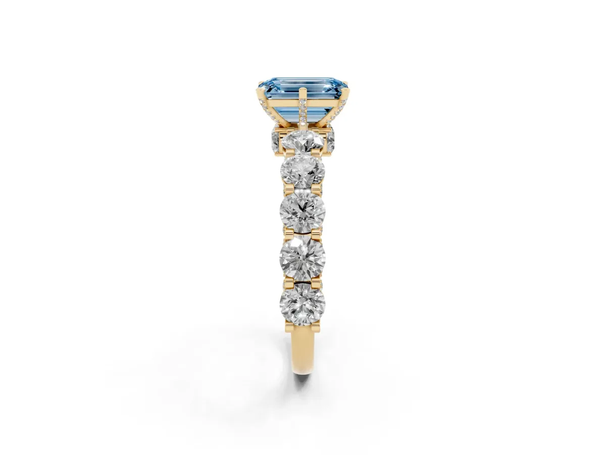 Fancy Blue Emerald Cut Diamond Side Stone Engagement Ring with Four-Prong Setting Yellow gold