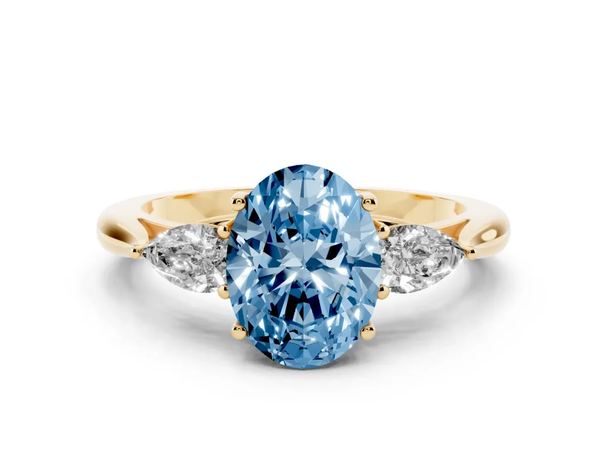 Fancy Blue Three-Stone Oval Cut Diamond Ring with Pear Side Stones in Four-Prong Setting Yellow gold