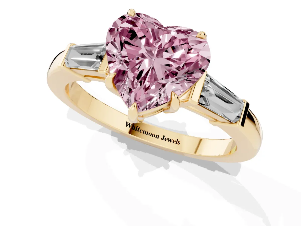 Fancy Pink Heart Cut Diamond Three-Stone Ring with Tapered Baguette Side Stones and Prong Setting Yellow gold