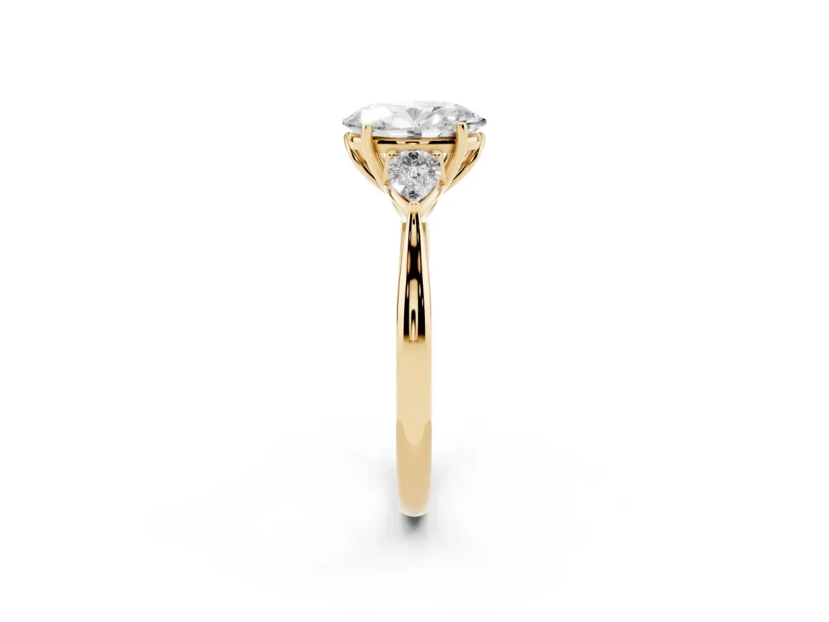 Three-Stone Oval Cut Diamond Ring with Pear Side Stones in Four-Prong Setting Yellow gold