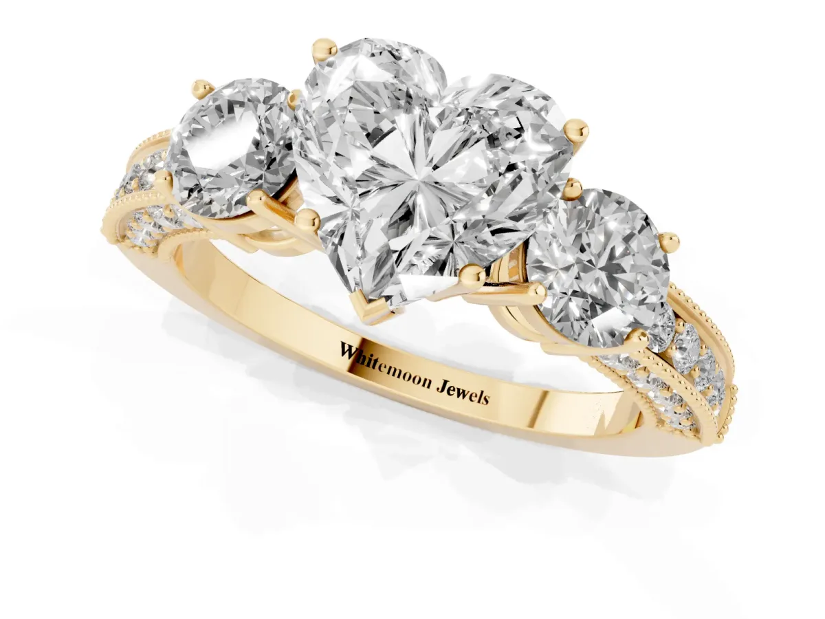 Heart Cut Three-Stone Diamond Ring with Pavé Band and Four-Prong Setting Yellow gold