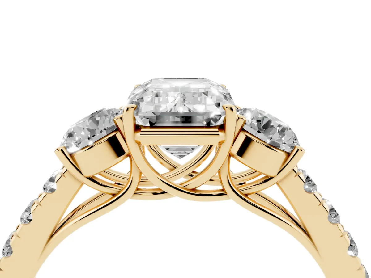 Emerald Cut Cut Diamond Three-Stone Ring with Round Side Stones and Pavé Band Yellow gold