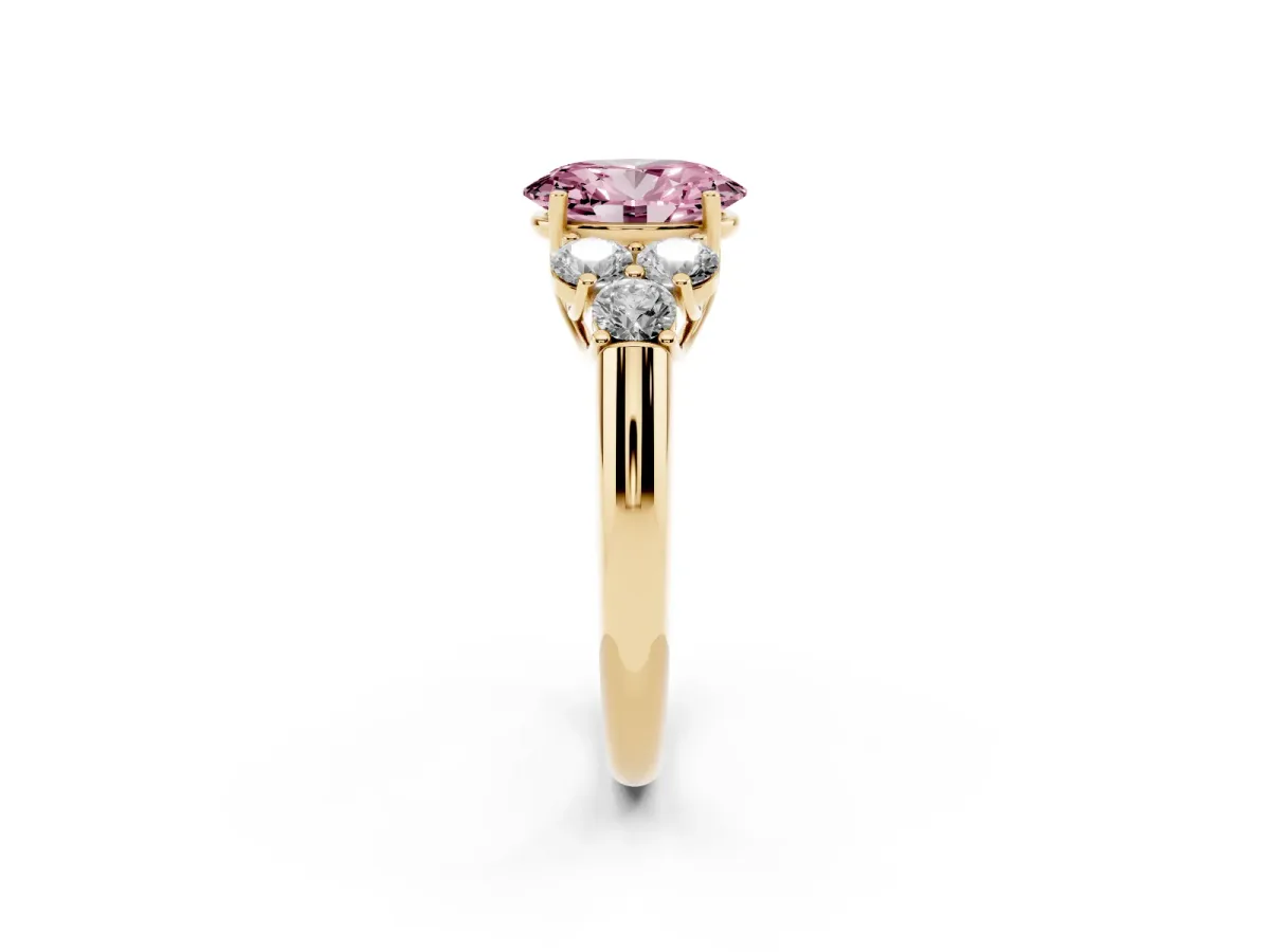 Fancy Pink Oval Cut Cut Diamond Cluster Ring with Round Accent Stones and Prong Setting on a Classic Band Yellow gold
