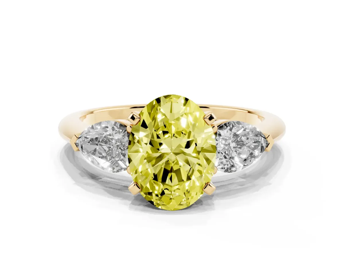 Fancy Yellow Three-Stone Oval Cut Diamond Ring with Pear Side Stones and Four-Prong Setting Yellow gold