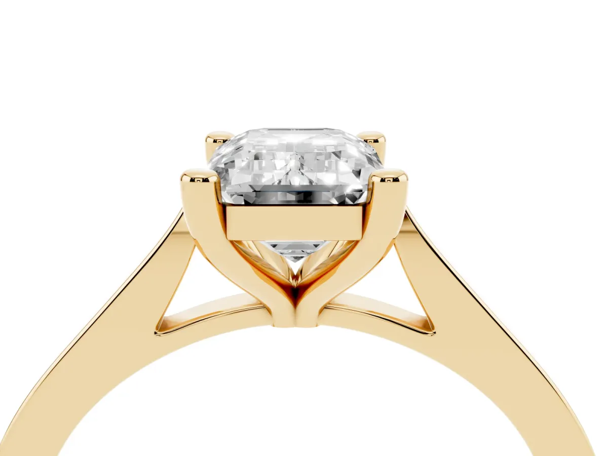 Emerald Cut Solitaire Diamond Ring with Four-Prong Setting and Tapered Band Yellow gold