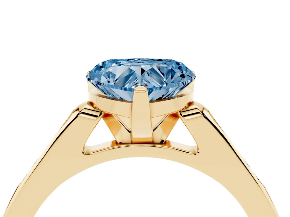 Fancy Blue Heart Cut Diamond Solitaire Ring with Channel Set Round Band and Prong Setting Yellow gold