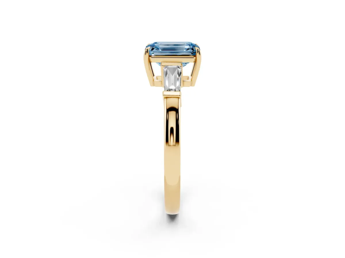 Fancy Blue Emerald Cut Diamond Three-Stone Ring with Tapered Baguette Side Stones and Prong Setting Yellow gold