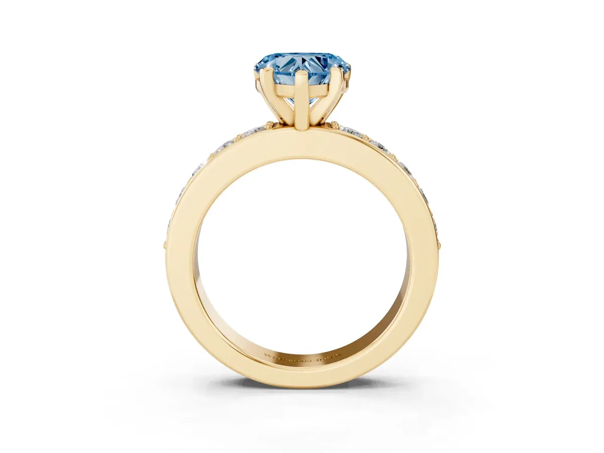 Fancy Blue Heart Cut Diamond Engagement Ring with Channel Set Round Band and Prong Setting Yellow gold