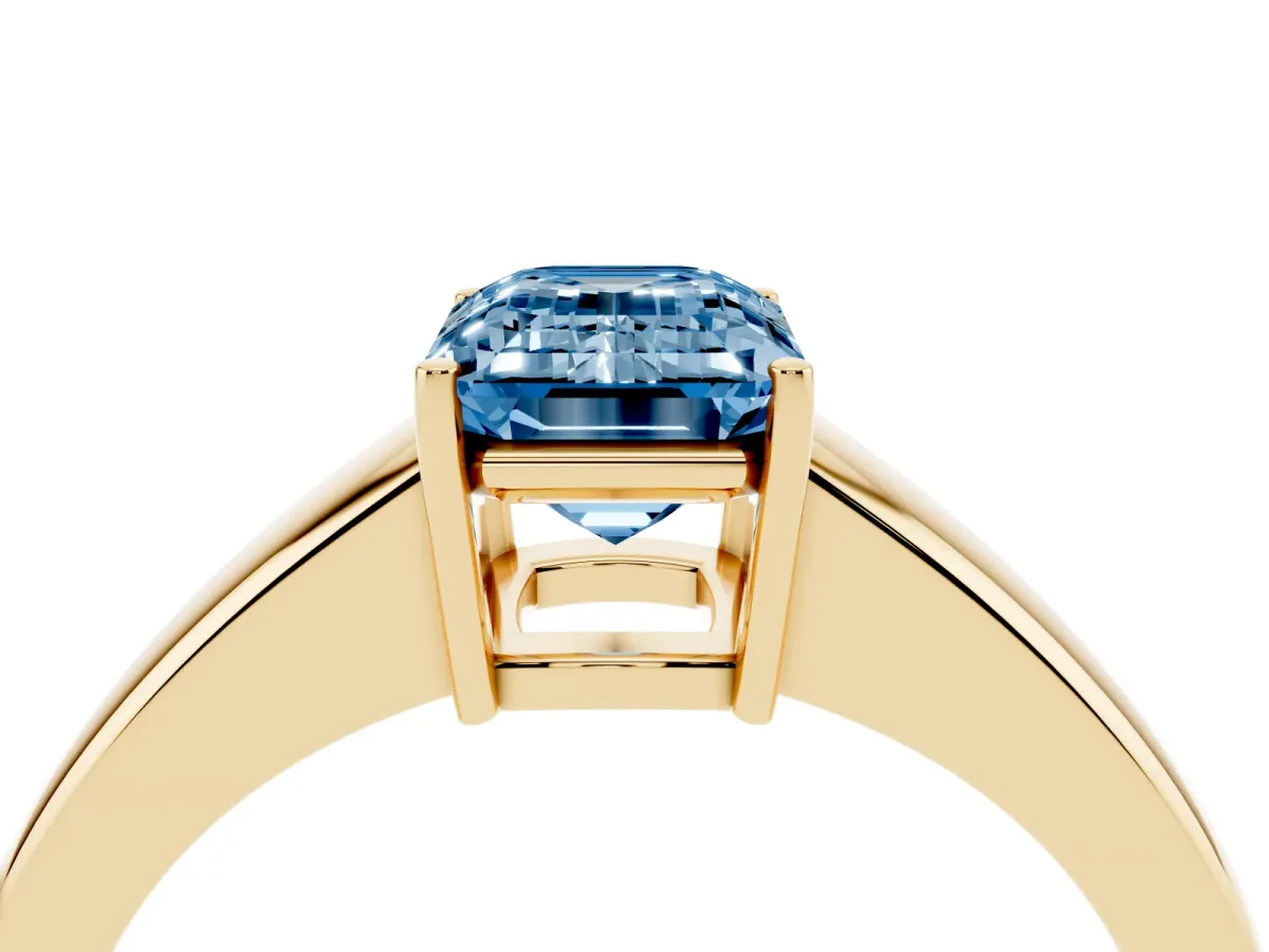 Fancy Blue Emerald Cut Solitaire Diamond Ring with Tapered Band and Four-Prong Setting Yellow gold